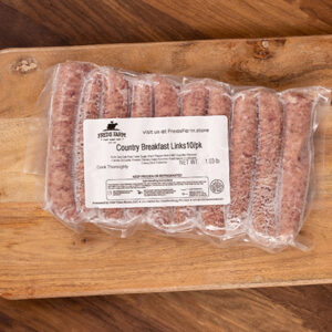Vacuum-sealed clear package of breakfast sausage links labeled 'Country Breakfast Links 10pk' resting on a wooden cutting board.