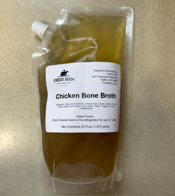 Pouch of Fred's Farm Chicken Bone Broth with a white label listing ingredients and 22 oz (1.375 pints) total.